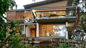 A neat house surrounded by trees that stimulate the emotions of a cheerful beach house using light wood and yellow pops2